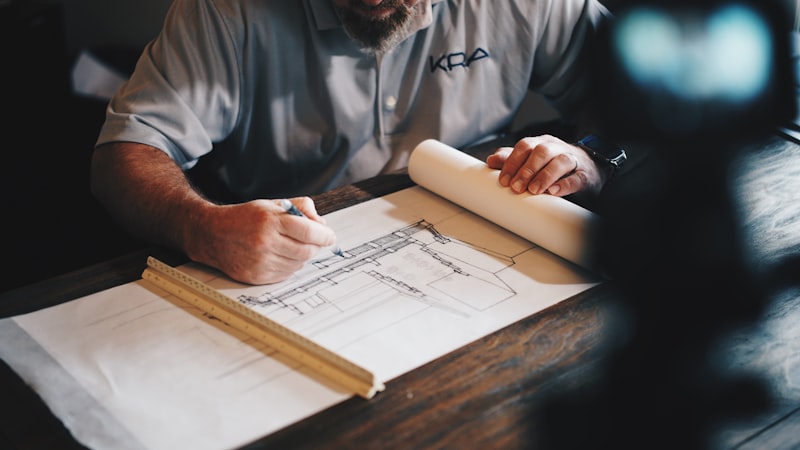 Architectural floor plan drawing on a drafting table